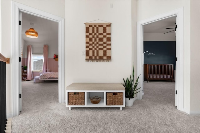 mudroom with carpet floors and radiator heating unit