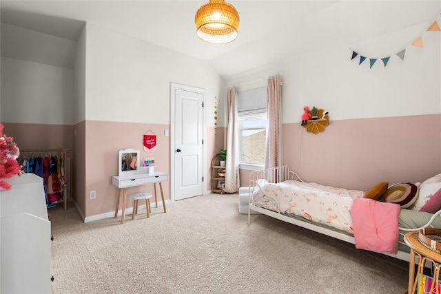 carpeted bedroom with lofted ceiling