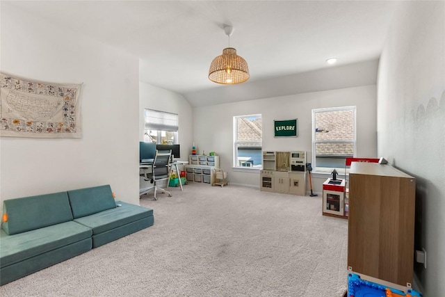 home office with lofted ceiling and carpet flooring