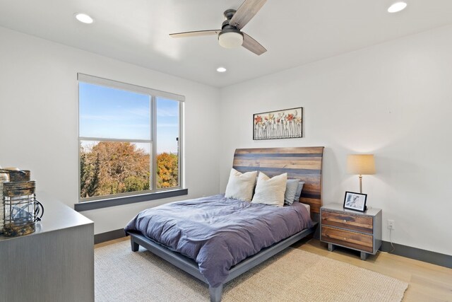 bedroom with ceiling fan and light hardwood / wood-style flooring