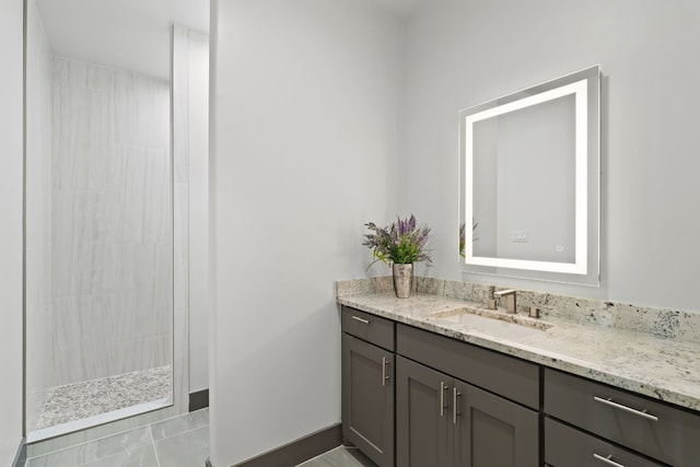 bathroom featuring a shower, vanity, and tile patterned floors