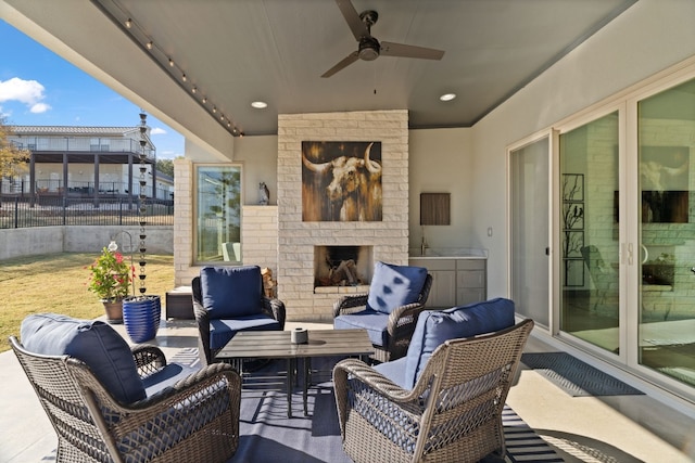 view of patio / terrace featuring an outdoor living space with a fireplace and ceiling fan