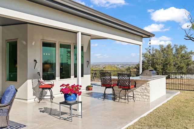 view of patio featuring an outdoor kitchen and a grill