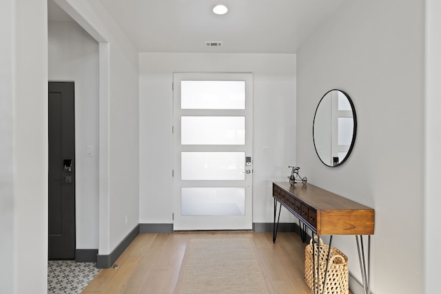 foyer entrance with light hardwood / wood-style floors