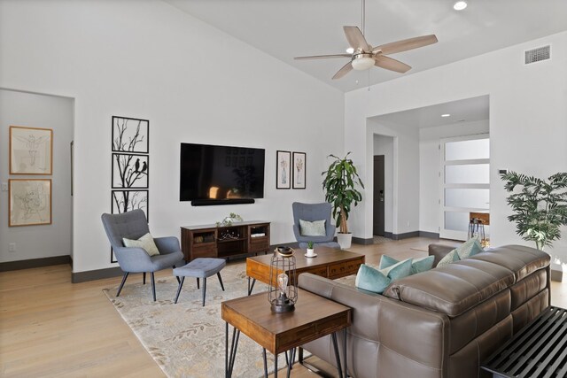 living room with ceiling fan and light wood-type flooring