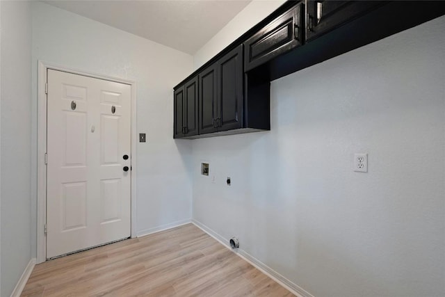 clothes washing area with cabinet space, light wood finished floors, baseboards, hookup for a washing machine, and hookup for an electric dryer