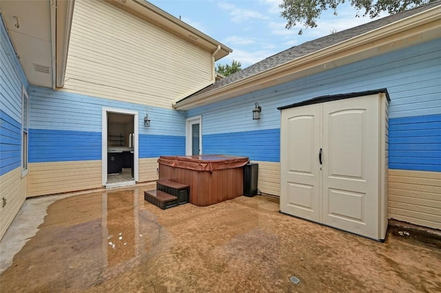 exterior space with a shed, an outdoor structure, and a hot tub