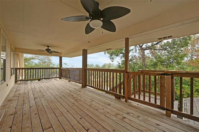 wooden terrace featuring ceiling fan and visible vents