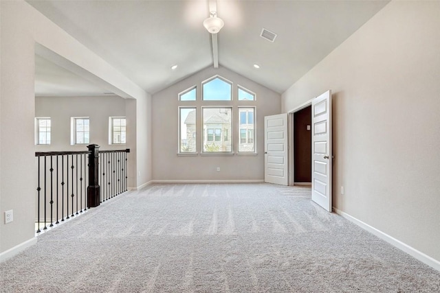 carpeted spare room featuring lofted ceiling with beams