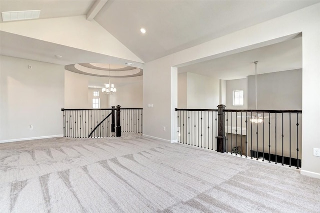 empty room featuring carpet, lofted ceiling with beams, and an inviting chandelier