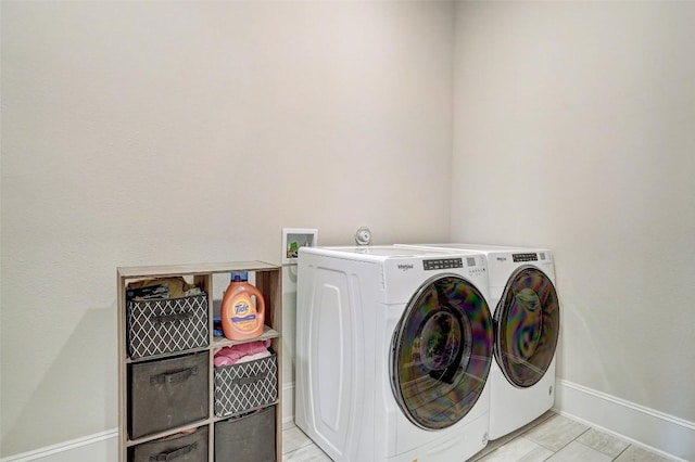 washroom featuring washing machine and clothes dryer and light tile patterned flooring