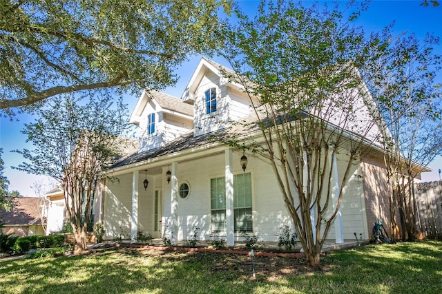 view of front of home with a porch and a front yard