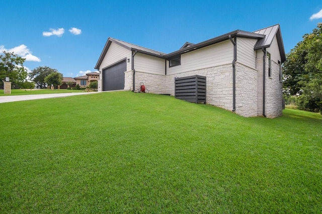 view of side of property with a lawn and a garage