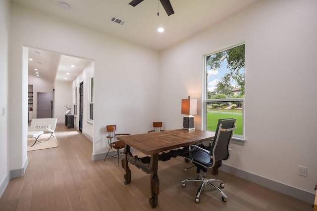 home office with light hardwood / wood-style flooring, ceiling fan, and lofted ceiling