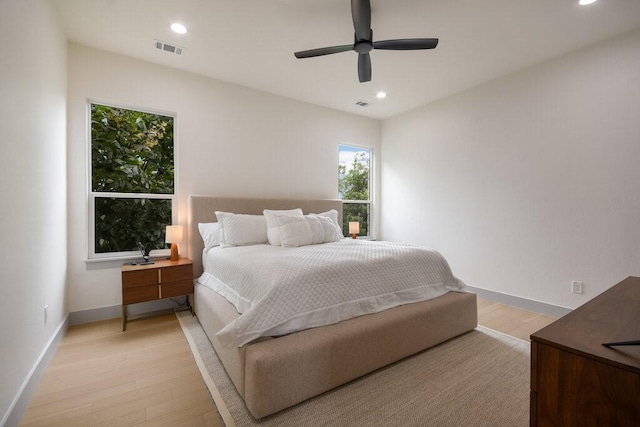 bedroom with ceiling fan and light hardwood / wood-style floors