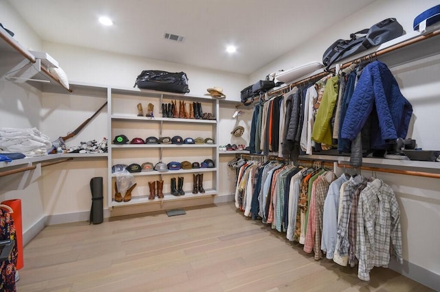 walk in closet featuring light hardwood / wood-style flooring