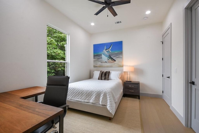 bedroom with ceiling fan and light hardwood / wood-style flooring