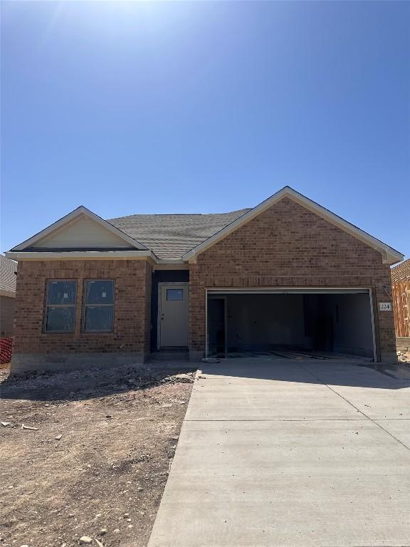 224 Lazy Lizzy Rd, Jarrell, TX 76537 - single story home with driveway, a garage, and brick siding