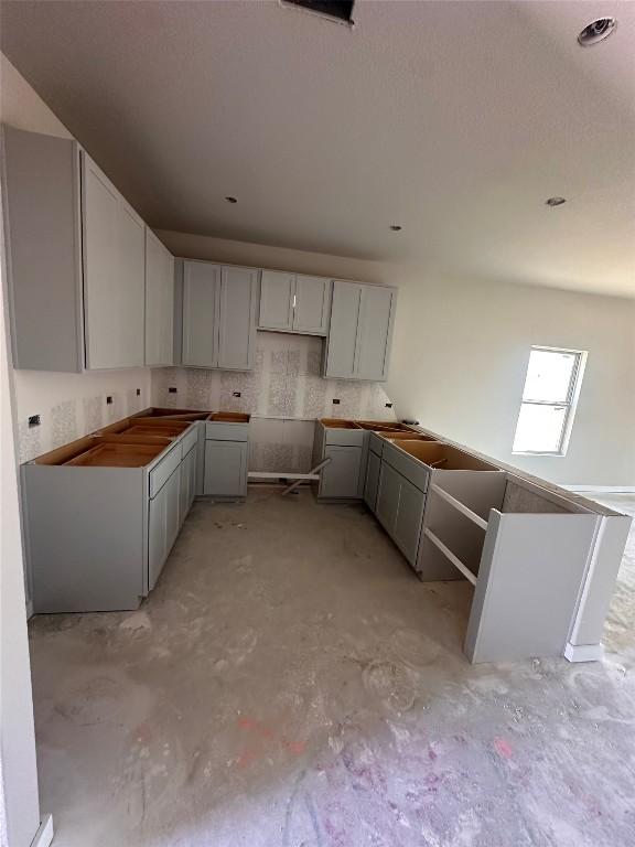 224 Lazy Lizzy Rd, Jarrell, TX 76537 - kitchen featuring unfinished concrete flooring and gray cabinets