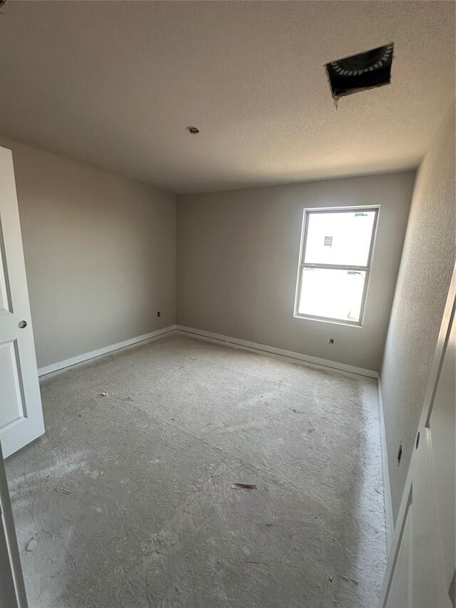 224 Lazy Lizzy Rd, Jarrell, TX 76537 - unfurnished room with baseboards and a textured ceiling