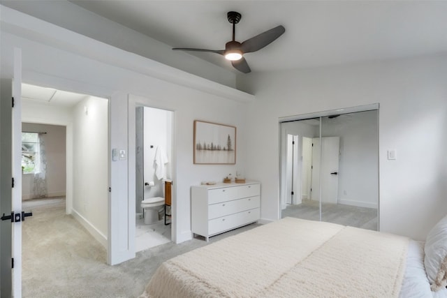 carpeted bedroom featuring lofted ceiling, connected bathroom, ceiling fan, and a closet