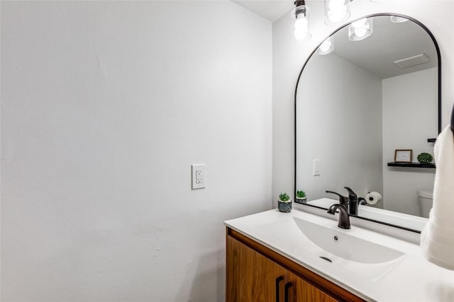 bathroom featuring vanity and toilet