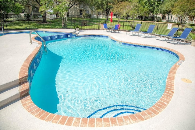 view of swimming pool with a patio area