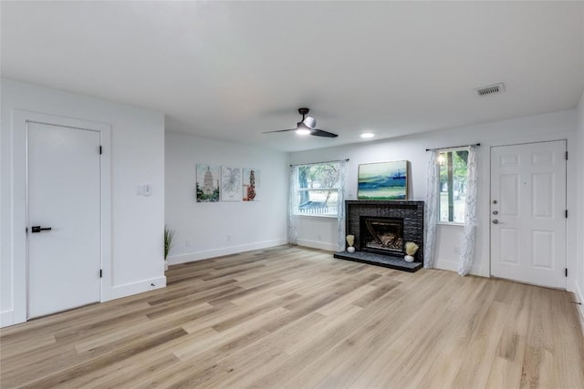 unfurnished living room with ceiling fan, a healthy amount of sunlight, and light hardwood / wood-style floors