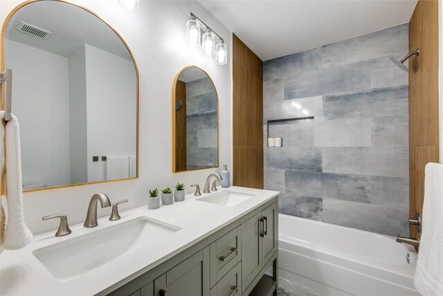 bathroom with vanity and tiled shower / bath