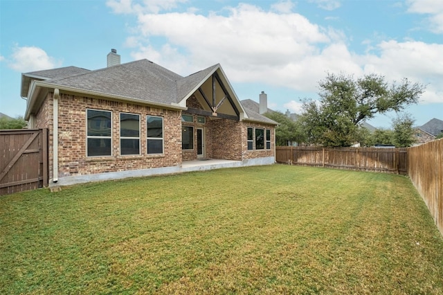 back of property featuring a yard