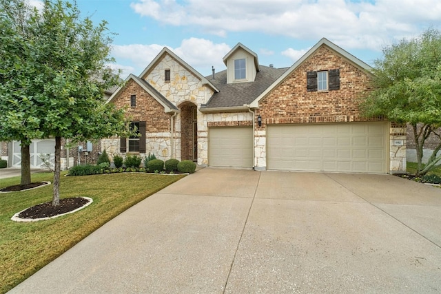 view of front of property with a garage and a front lawn