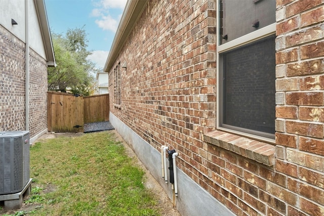 view of side of home with central AC unit