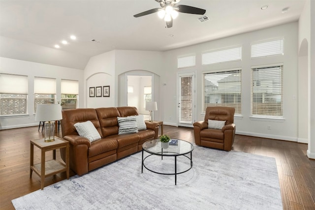 living room featuring ceiling fan and dark hardwood / wood-style flooring