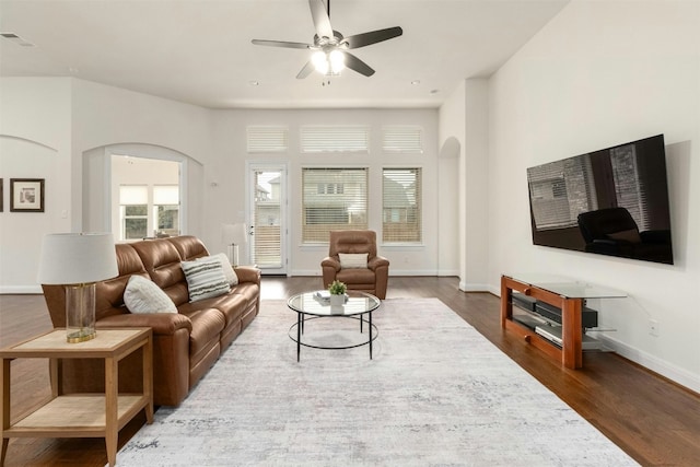 living room with dark hardwood / wood-style floors and ceiling fan