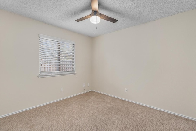 carpeted empty room with a textured ceiling and ceiling fan