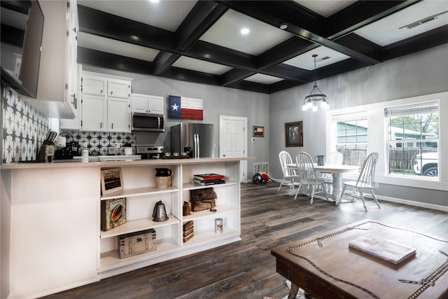 kitchen featuring white cabinets, appliances with stainless steel finishes, pendant lighting, and coffered ceiling