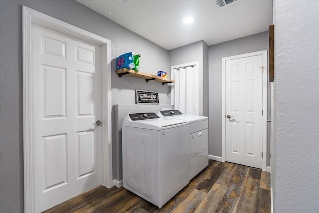 laundry area featuring dark hardwood / wood-style flooring and washer and dryer