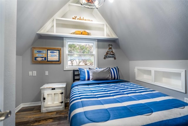 bedroom with lofted ceiling and dark hardwood / wood-style floors