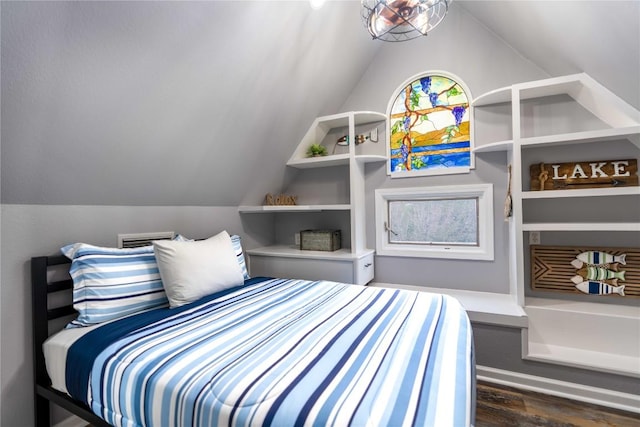 bedroom featuring dark hardwood / wood-style flooring and lofted ceiling