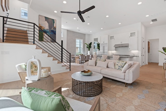 living room featuring ceiling fan and light hardwood / wood-style flooring