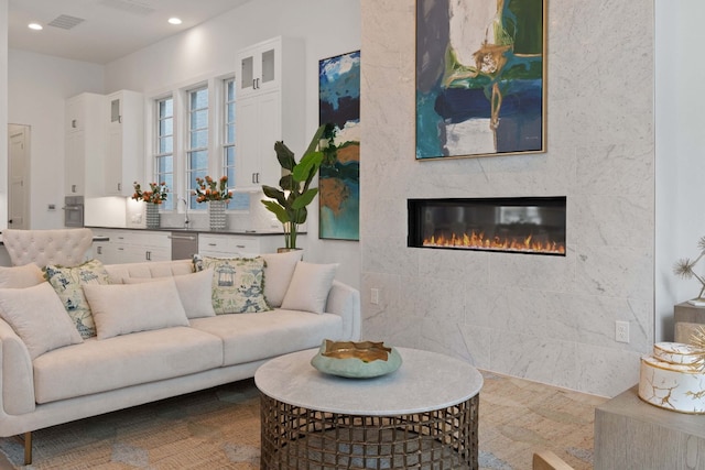 living room with a large fireplace and sink