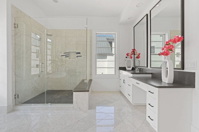 bathroom featuring vanity, a healthy amount of sunlight, and an enclosed shower