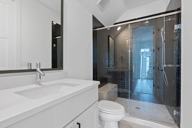 bathroom with vanity, toilet, lofted ceiling, and a shower with door