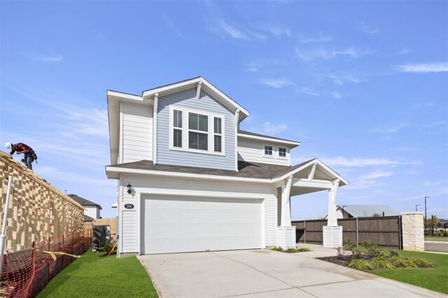 view of front of property with a front yard and a garage