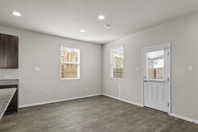 unfurnished dining area with dark hardwood / wood-style floors