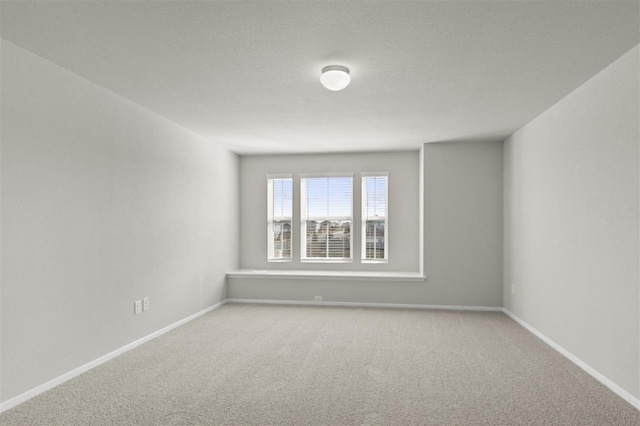 empty room with light colored carpet