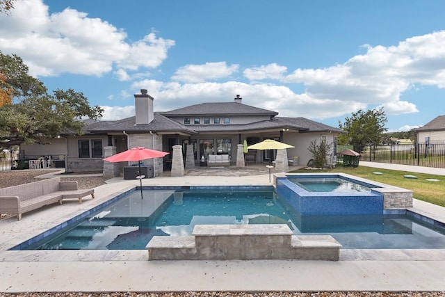 view of swimming pool with a patio area and an in ground hot tub