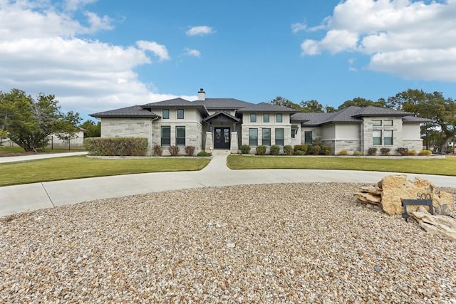 prairie-style home featuring a front lawn