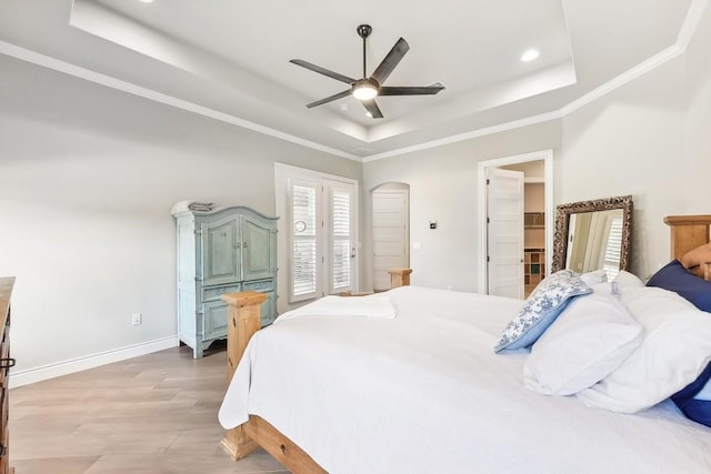 bedroom featuring access to outside, a tray ceiling, ceiling fan, crown molding, and hardwood / wood-style flooring