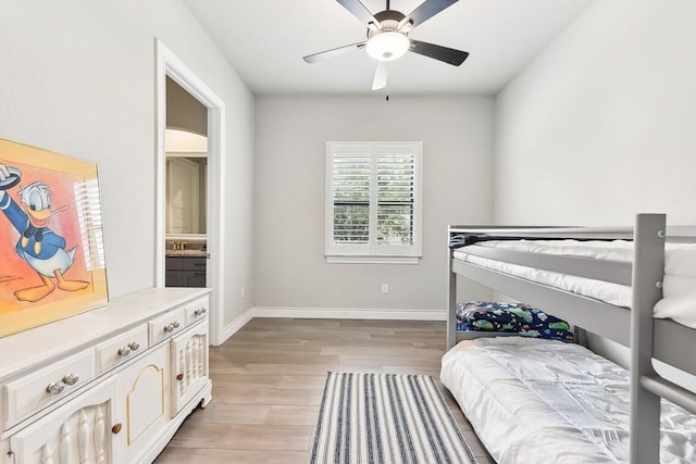 bedroom with light hardwood / wood-style floors, ceiling fan, and ensuite bathroom